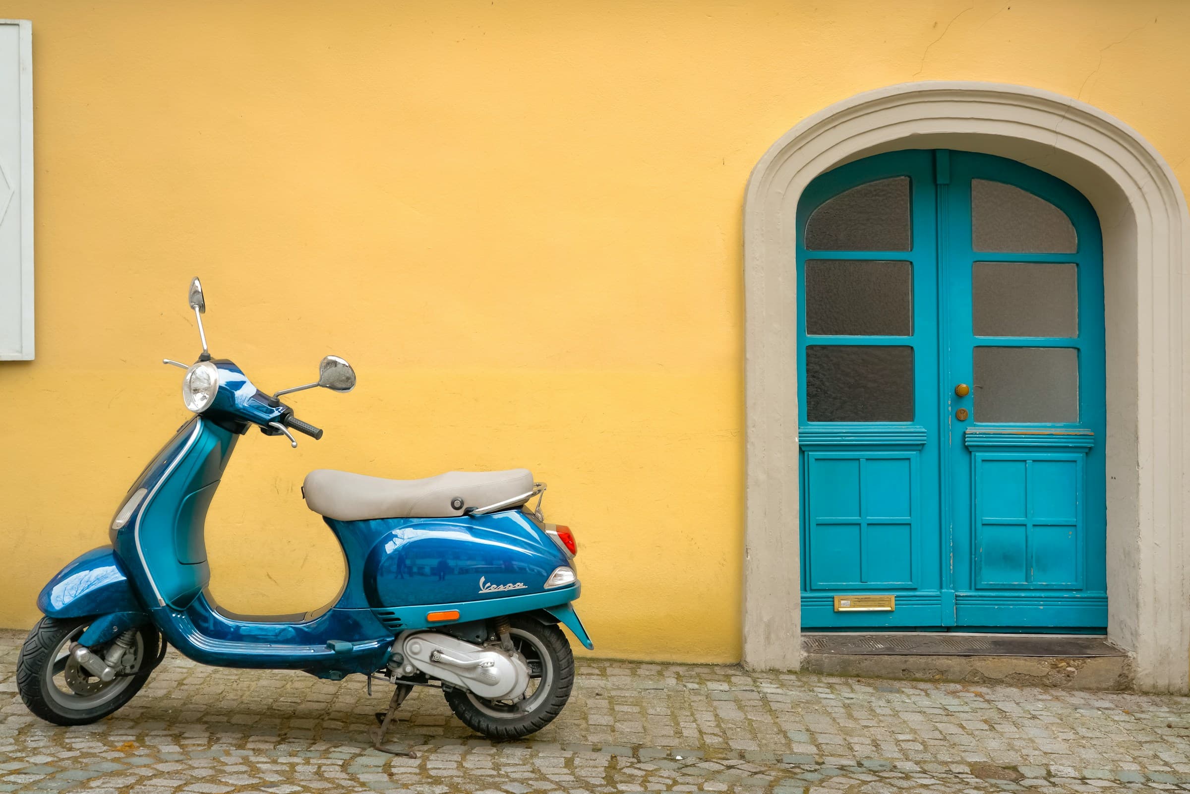 Blue scooter on a tropical beach setting
